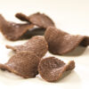 Milk Chocolate Potato Chips scattered on white background to reveal size, shape and texture of chip.